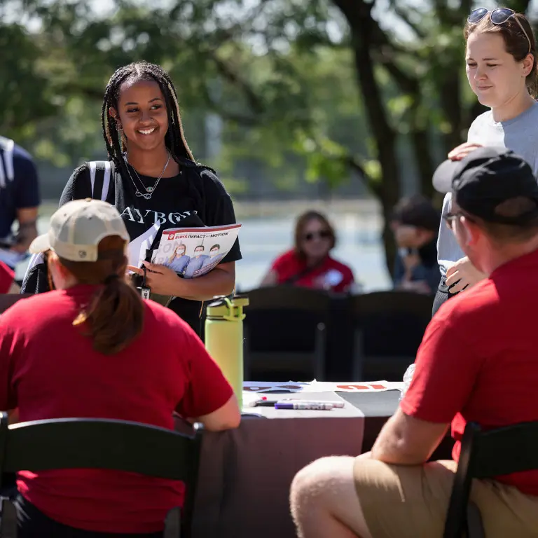 A student stops at an info table